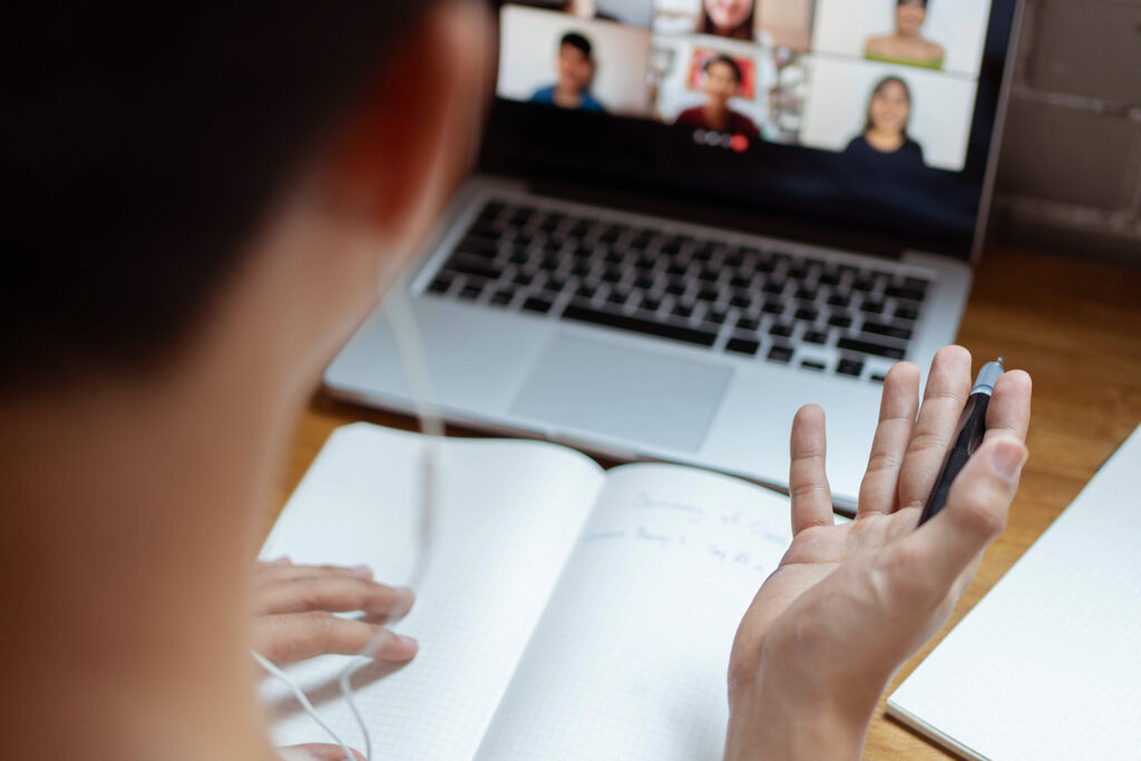 Online studying concept the university student trying to explain his opinion towards the subject that he concludes on the notebook while his classmates are listening to it.