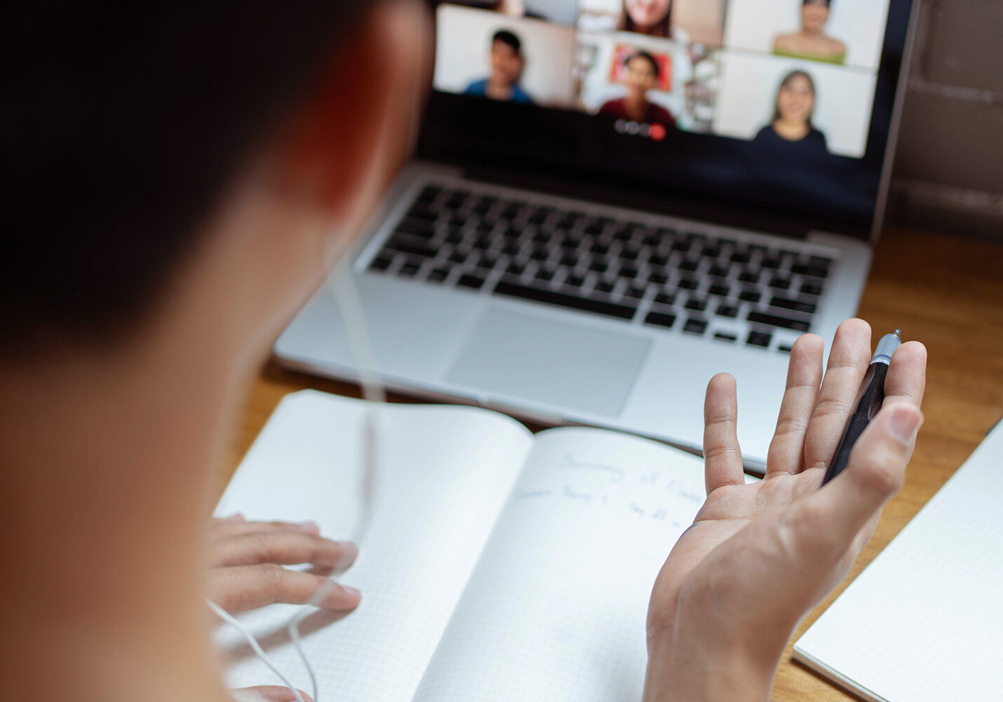 Online studying concept the university student trying to explain his opinion towards the subject that he concludes on the notebook while his classmates are listening to it.